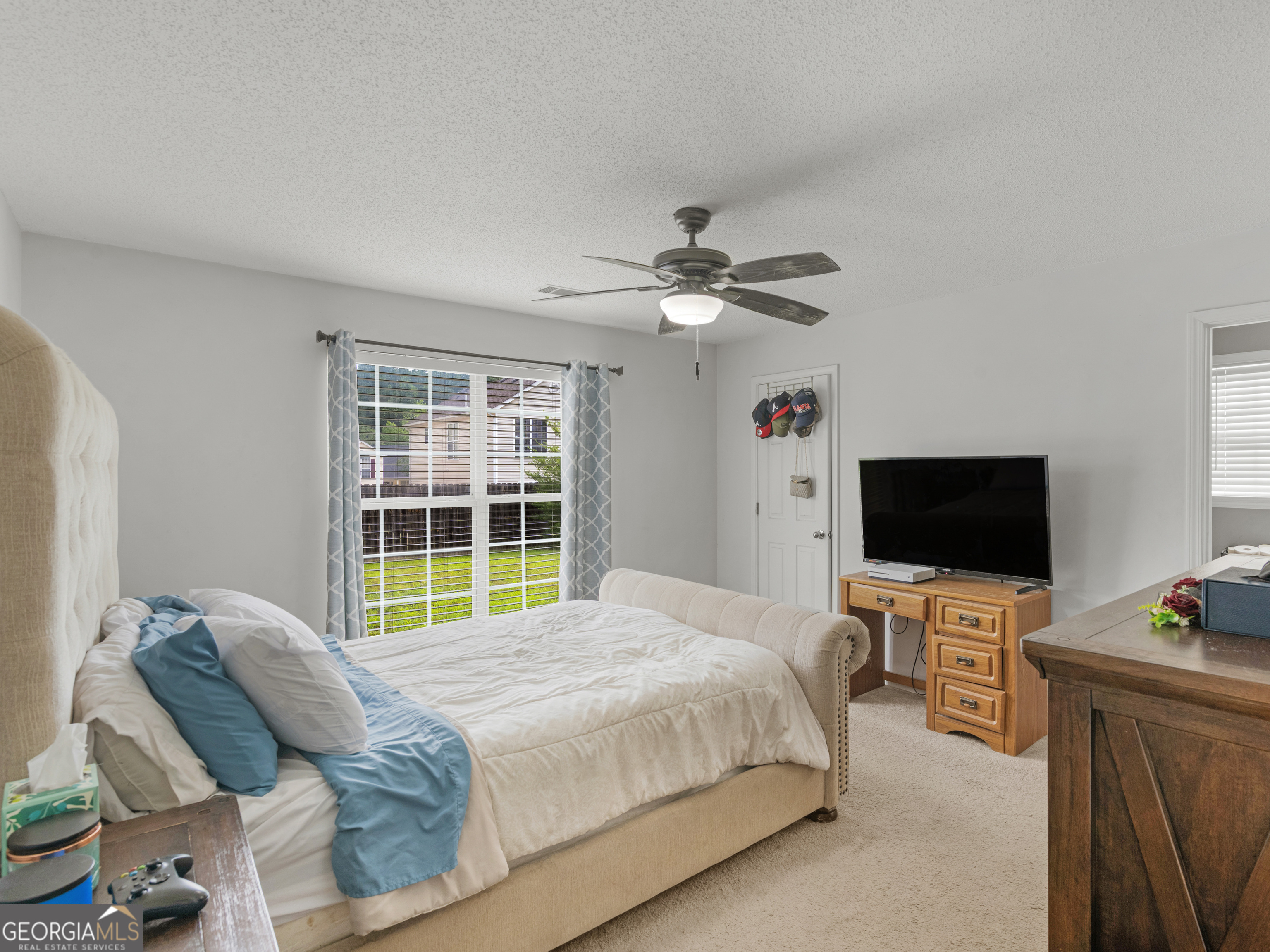3370 Waggoner Place Rex, GA 30273 - Photo 13 of 25 a bedroom with a bed and a flat screen tv
