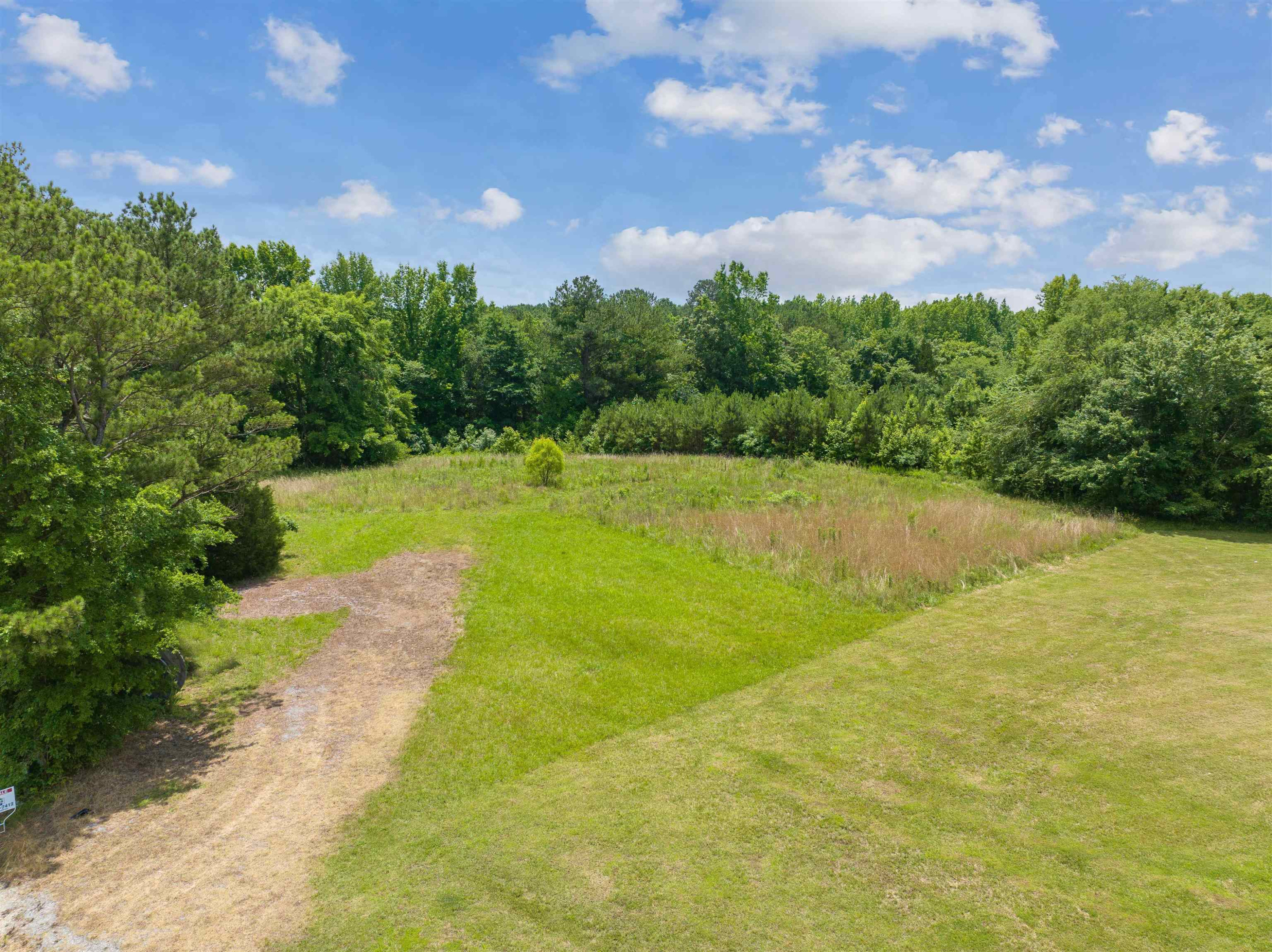 a view of a big yard with lots of green space