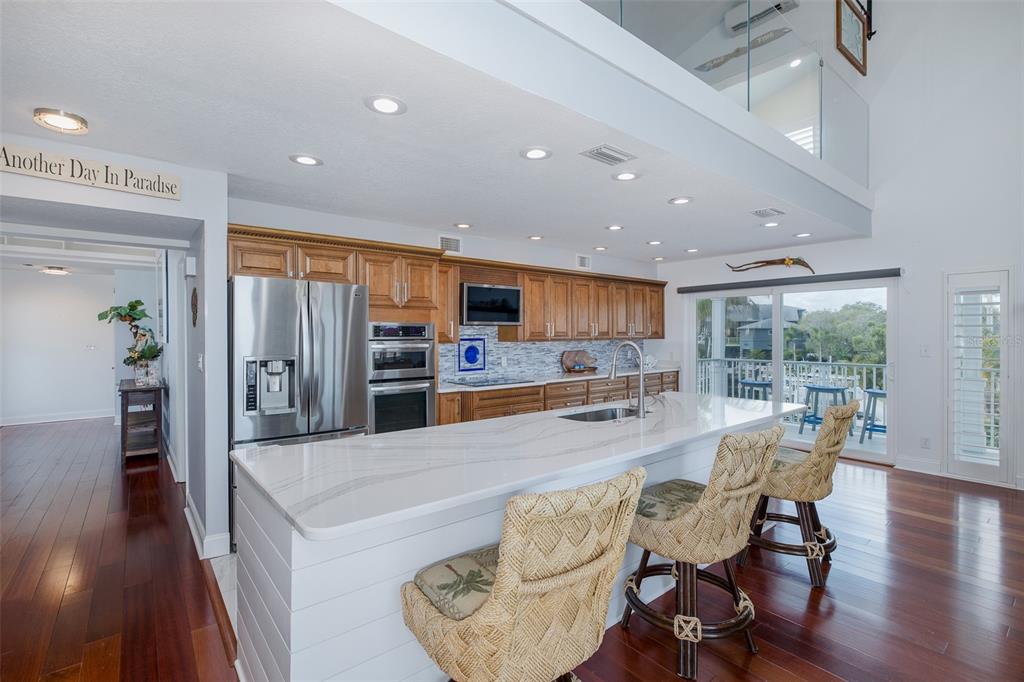 5040 Waterside Drive Port Richey, FL 34668 - Photo 12 of 58 a large kitchen with a table and chairs
