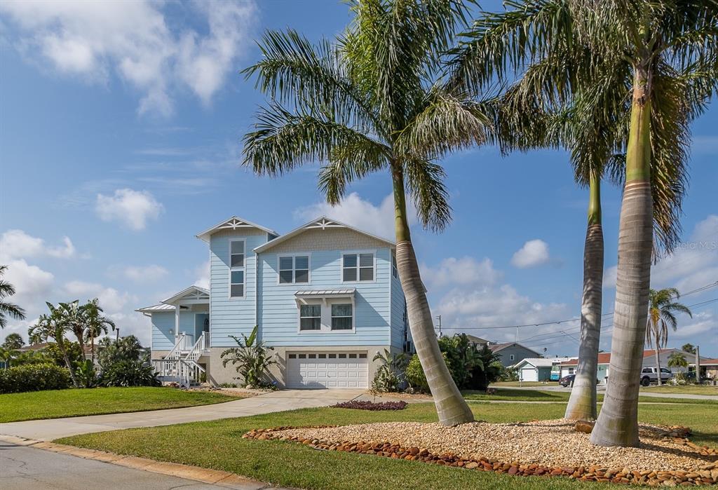 5040 Waterside Drive Port Richey, FL 34668 - Photo 2 of 58 a front view of a house with a garden