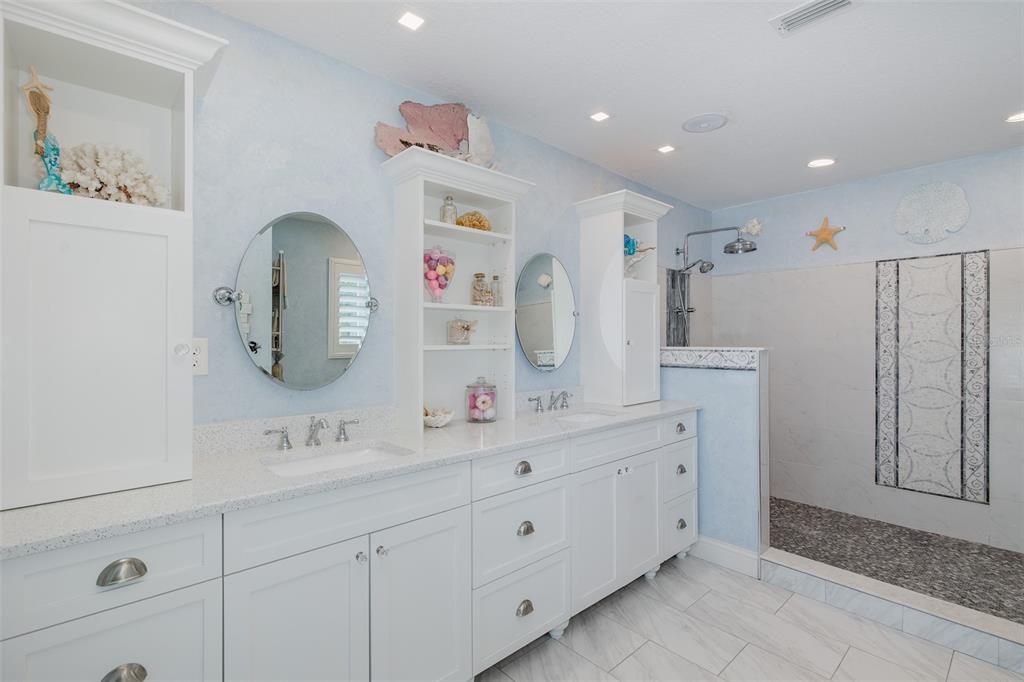 5040 Waterside Drive Port Richey, FL 34668 - Photo 22 of 58 a bathroom with double vanity sink and a mirror