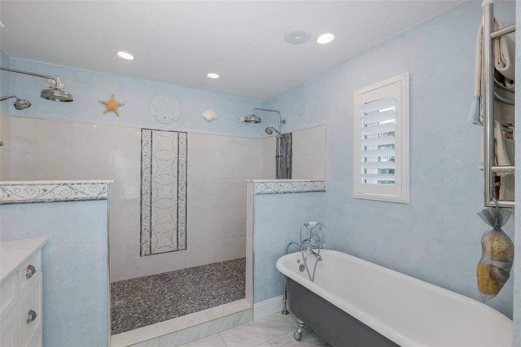 5040 Waterside Drive Port Richey, FL 34668 - Photo 23 of 58 a bathroom with a tub sink and mirror