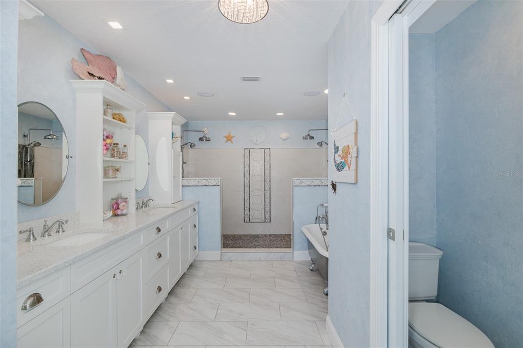 5040 Waterside Drive Port Richey, FL 34668 - Photo 24 of 58 a bathroom with a double vanity sink mirror and shower