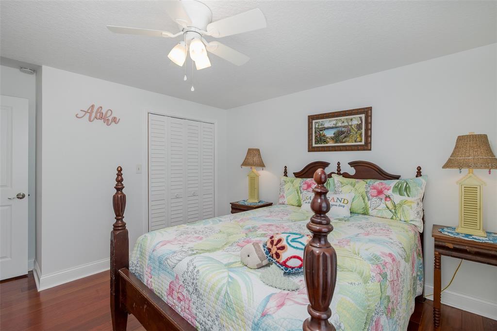 5040 Waterside Drive Port Richey, FL 34668 - Photo 25 of 58 a bedroom with a bed and a chandelier
