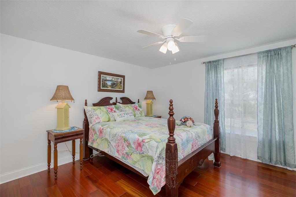 5040 Waterside Drive Port Richey, FL 34668 - Photo 26 of 58 a bedroom with a bed and a wooden floor