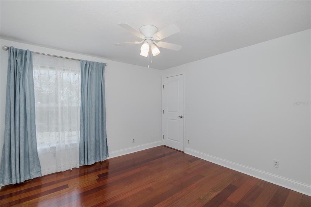 5040 Waterside Drive Port Richey, FL 34668 - Photo 28 of 58 wooden floor in an empty room with a window