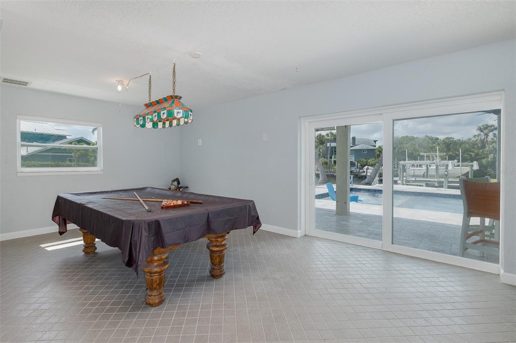 5040 Waterside Drive Port Richey, FL 34668 - Photo 39 of 58 a room with pool table and glass door