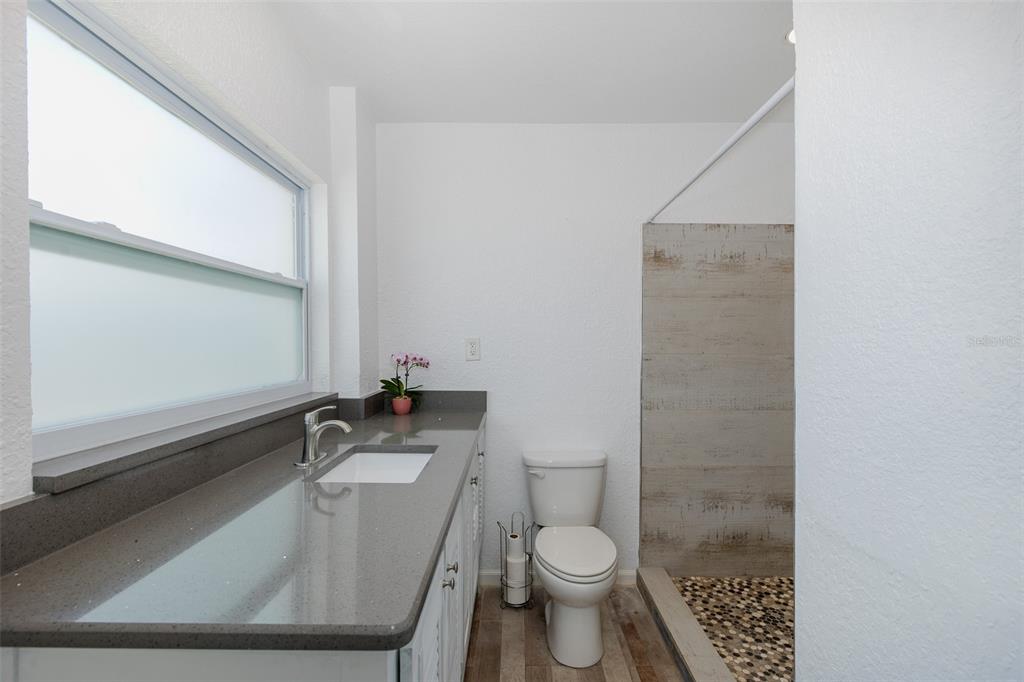 5040 Waterside Drive Port Richey, FL 34668 - Photo 41 of 58 a bathroom with a sink a toilet and a mirror