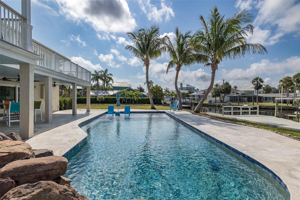 5040 Waterside Drive Port Richey, FL 34668 - Photo 44 of 58 a view of a swimming pool with lounge chair