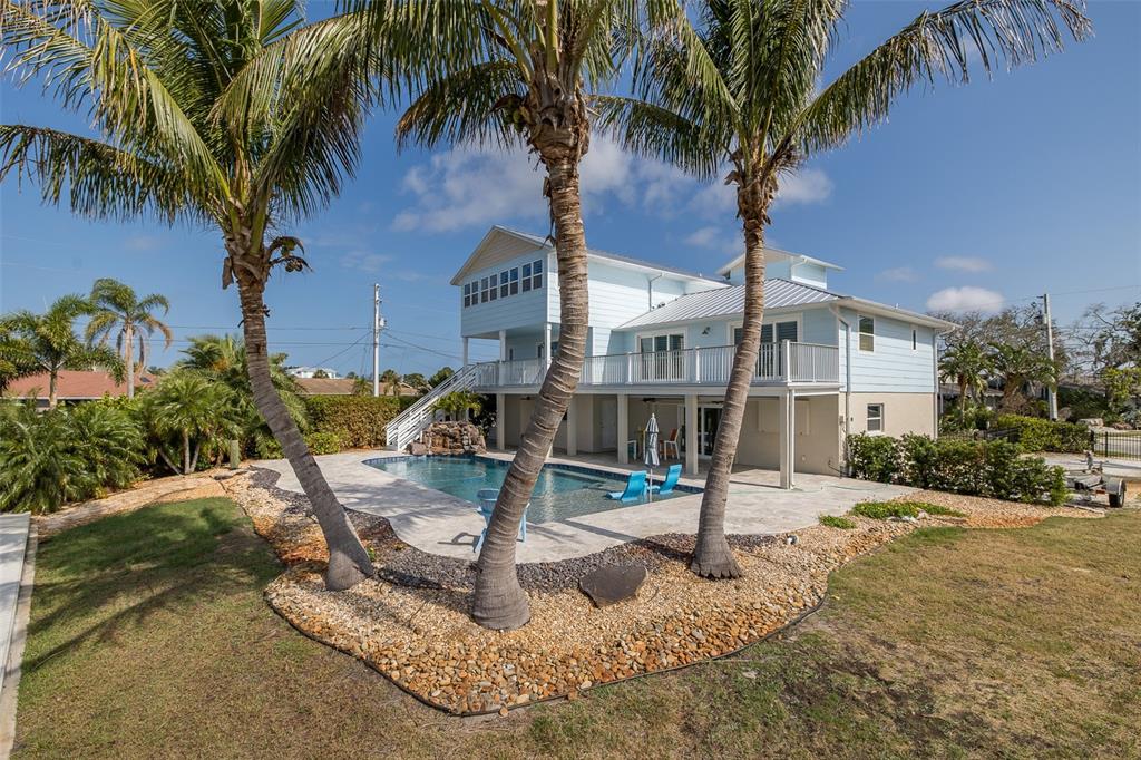 5040 Waterside Drive Port Richey, FL 34668 - Photo 45 of 58 a front view of a house with garden and trees