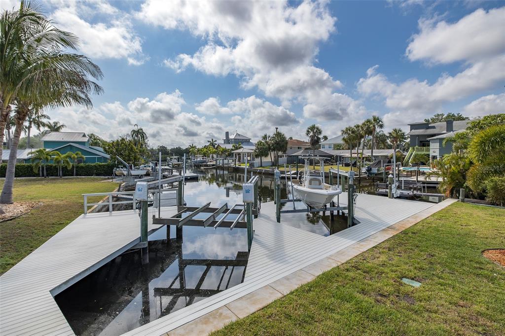 5040 Waterside Drive Port Richey, FL 34668 - Photo 47 of 58 a view of a swimming pool with lawn chairs and a fire pit