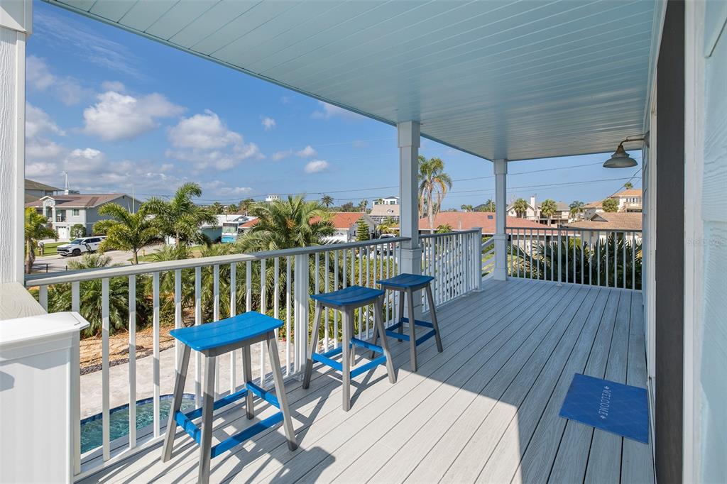 5040 Waterside Drive Port Richey, FL 34668 - Photo 49 of 58 a view of a balcony with wooden floor and outdoor seating