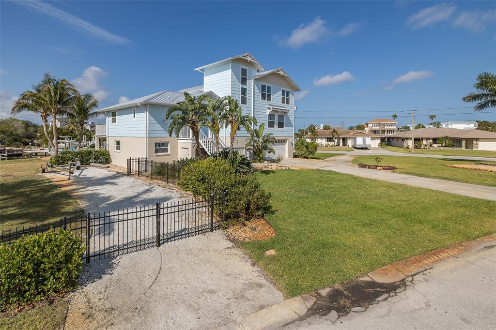 5040 Waterside Drive Port Richey, FL 34668 - Photo 51 of 58 a front view of a house with a yard