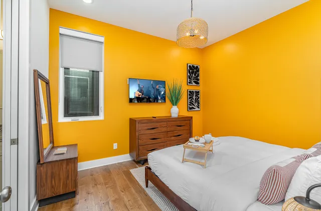 a bedroom with a bed and a flat screen tv