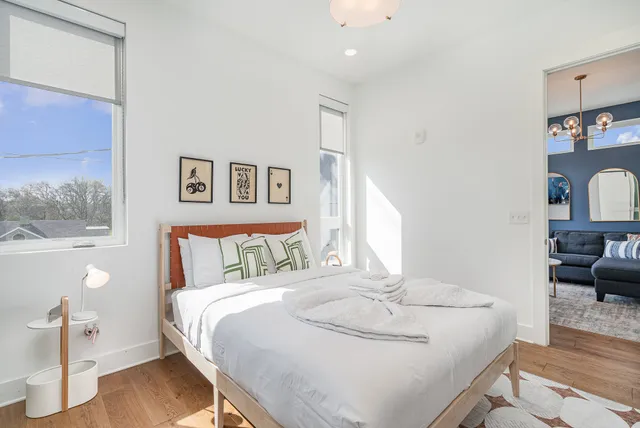 a bedroom with a bed and wooden floor