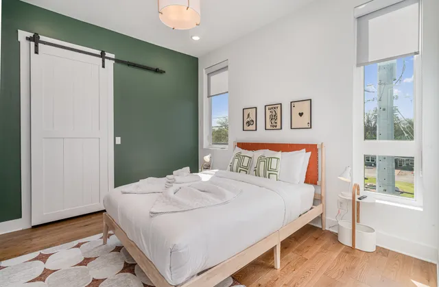 a bedroom with a bed and a window