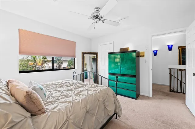 a bed sitting in a bedroom next to a window