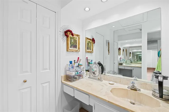 a bathroom with a sink vanity and a mirror