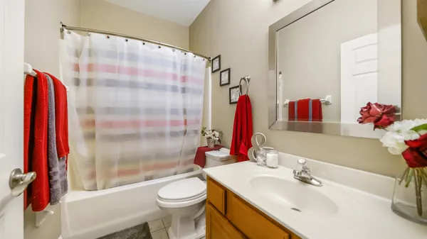 a bathroom with a sink vanity mirror and toilet