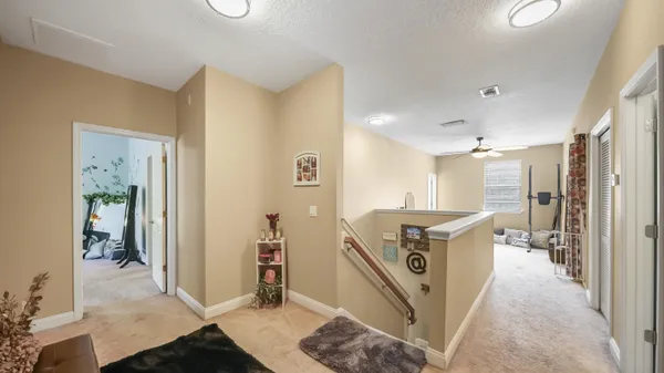 a view of a kitchen with kitchen island stainless steel appliances wooden floor and furniture
