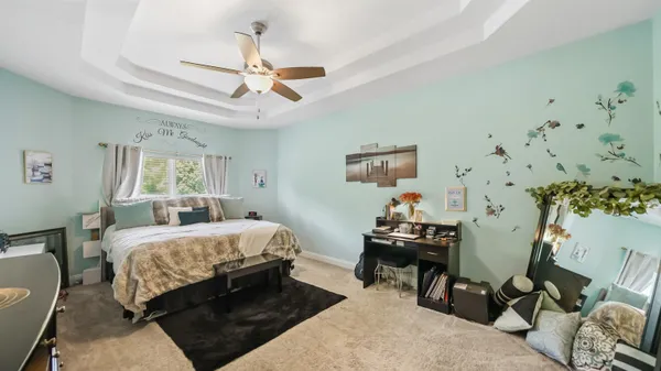 a bedroom with bed and a chandelier