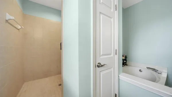 a bathroom with a tub and shower