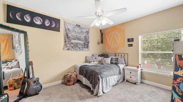 a bedroom with a bed and a window