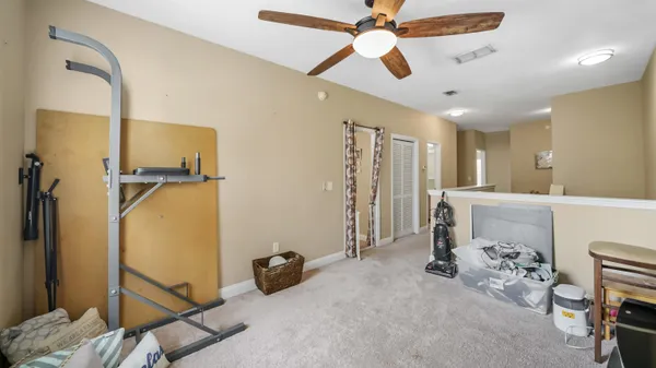 a view of a livingroom with furniture and a ceiling fan
