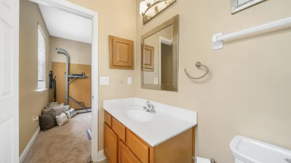 a bathroom with a sink vanity mirror and toilet