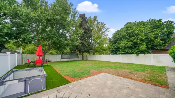 a view of a backyard with swimming pool