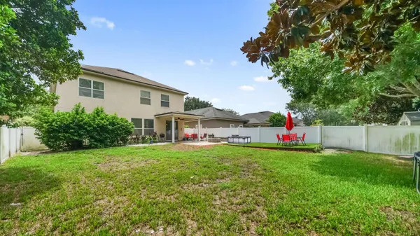 a house view with a sitting space and garden