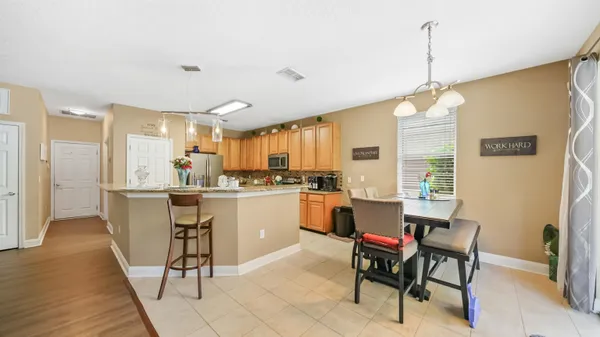 a kitchen with kitchen island white cabinets and stainless steel appliances