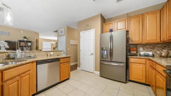 a kitchen with stainless steel appliances granite countertop a refrigerator and a sink