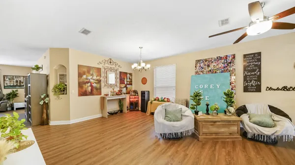 a living room with furniture and wooden floor