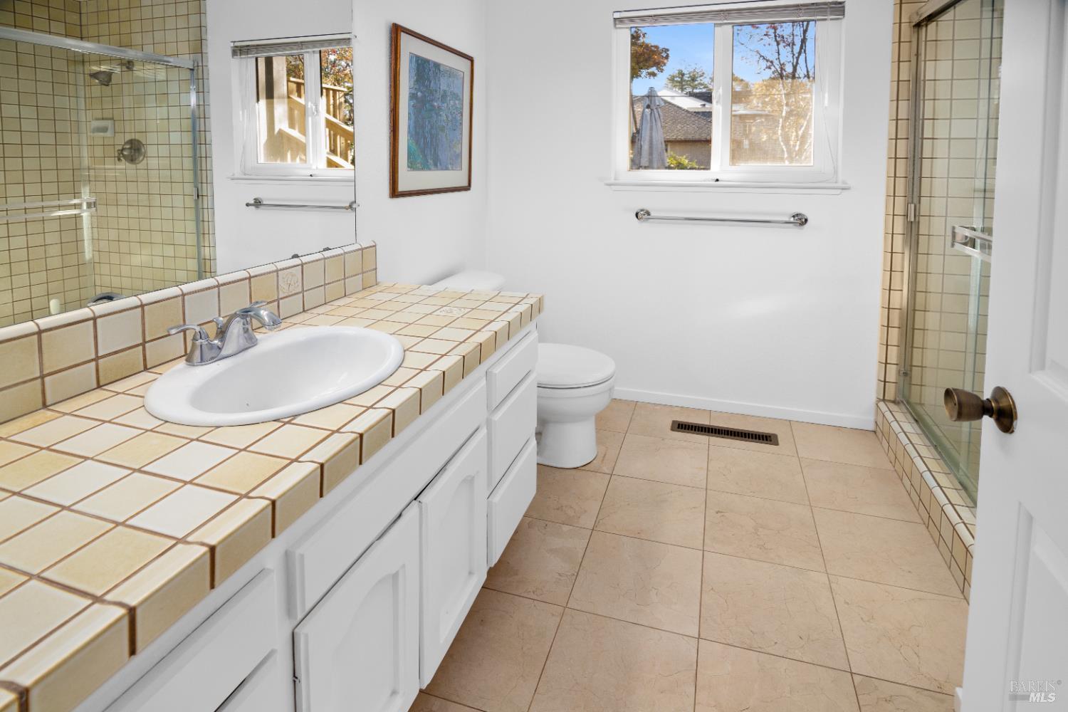 4808 Foxglove Court Santa Rosa, CA 95405 - Photo 12 of 26 a bathroom with a sink a toilet and a mirror