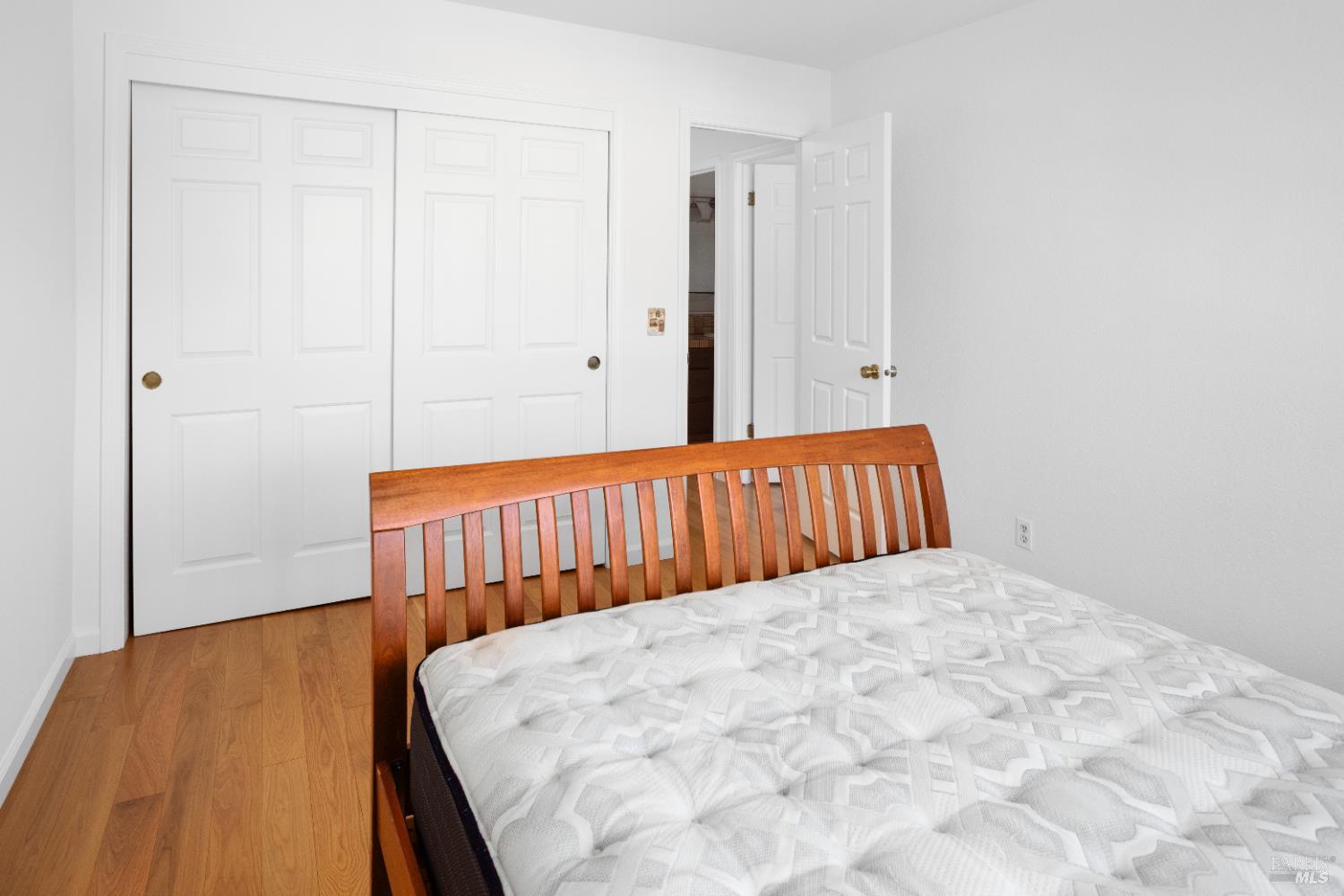 4808 Foxglove Court Santa Rosa, CA 95405 - Photo 16 of 26 a bedroom with a bed and wooden floor