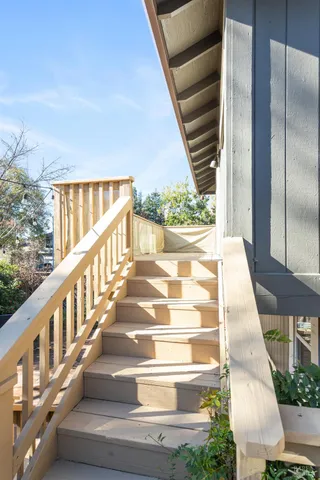 a view of staircase with white walls and windows