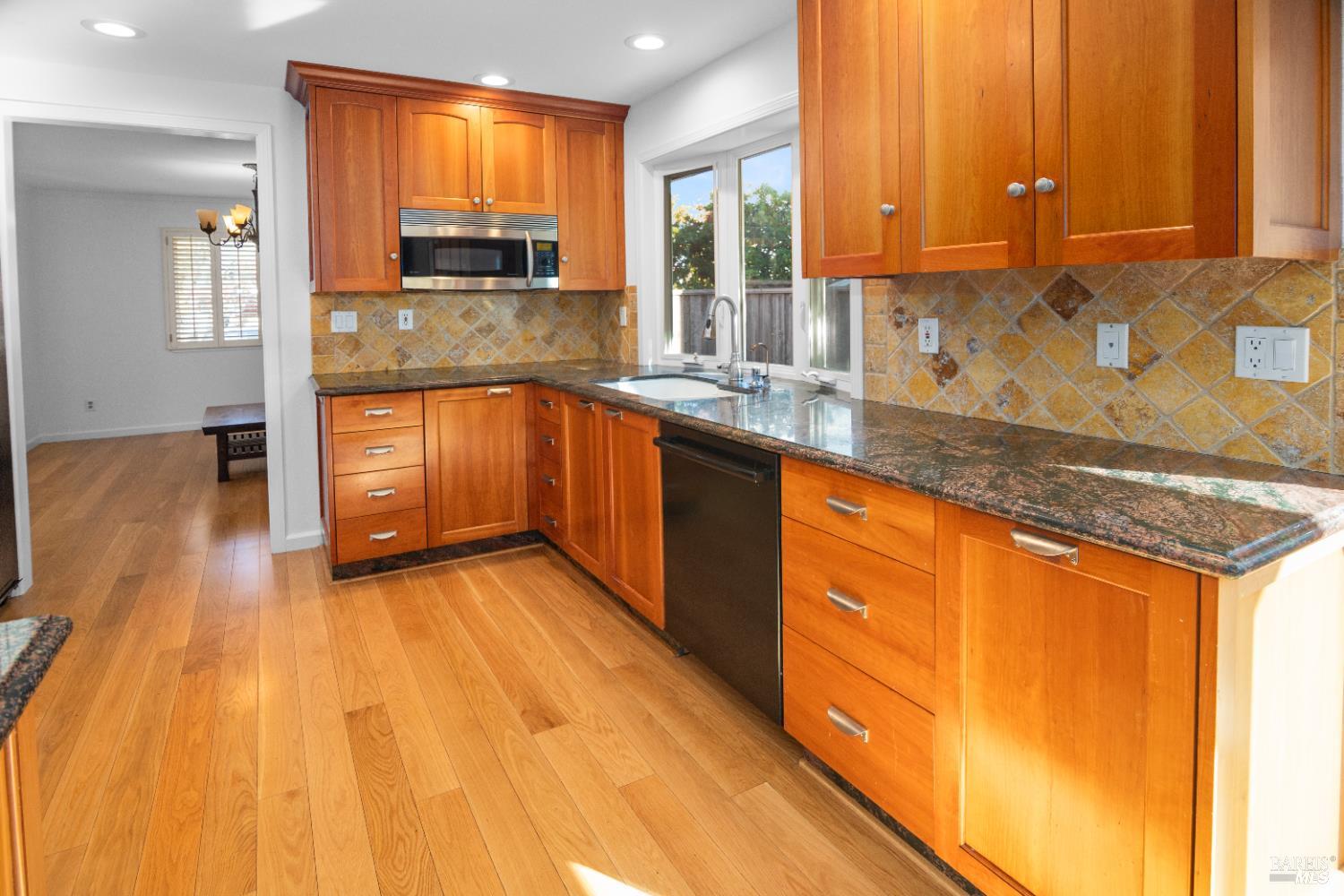 4808 Foxglove Court Santa Rosa, CA 95405 - Photo 5 of 26 a kitchen with stainless steel appliances granite countertop a sink a stove cabinets and wooden floor