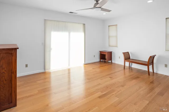 a view of work space with wooden floor and furniture