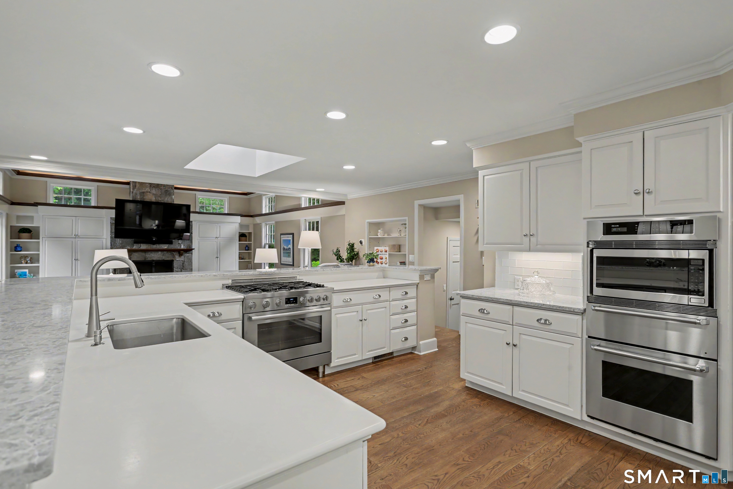 108 Logan Road New Canaan, CT 06840 - Photo 7 of 40 a kitchen with white cabinets and stainless steel appliances