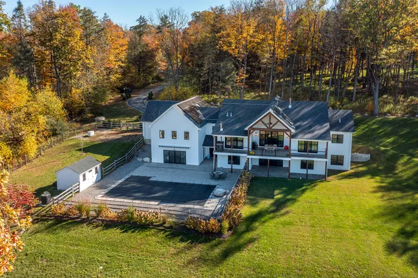 a aerial view of a house with swimming pool next to a yard