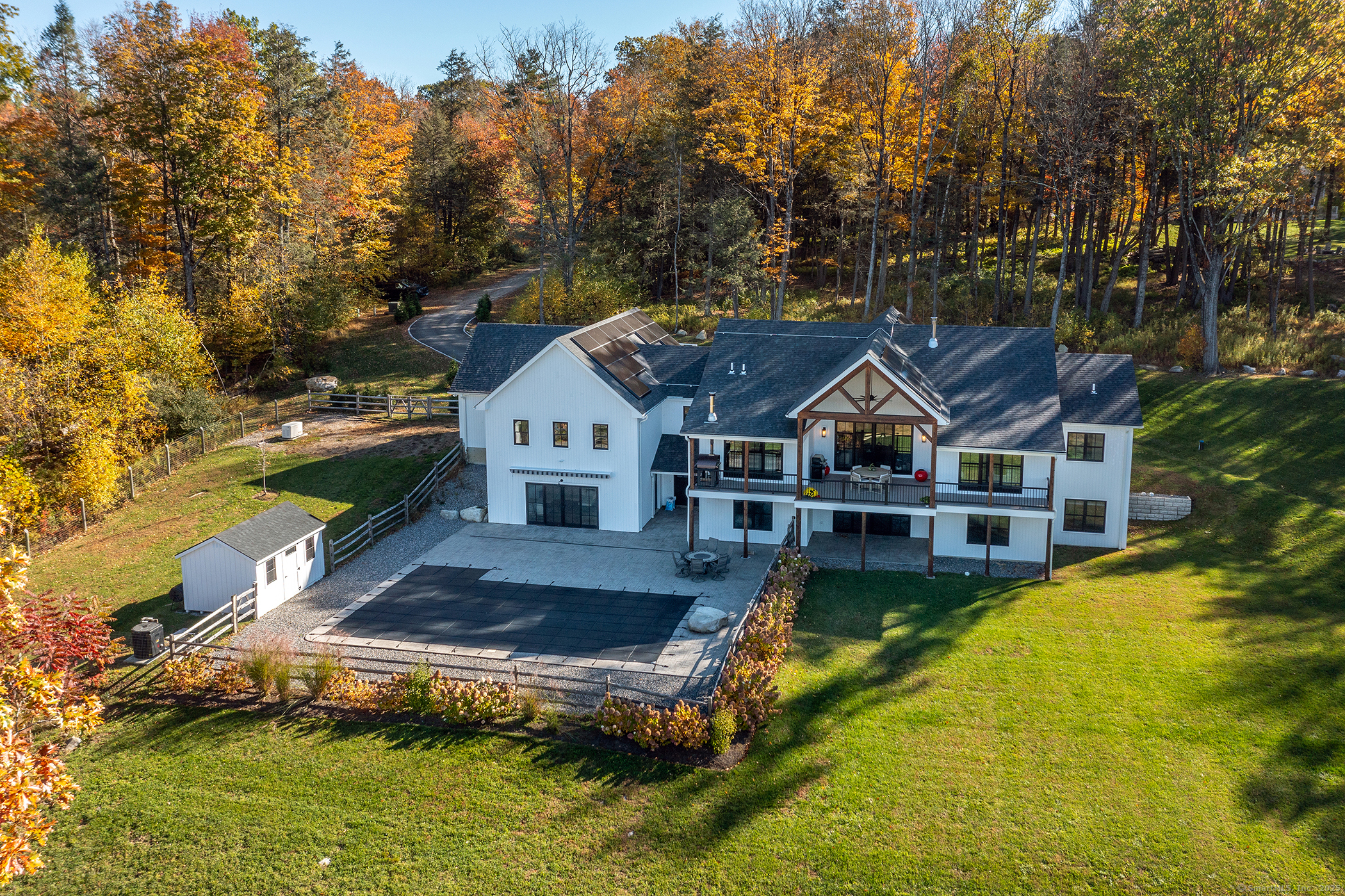 a aerial view of a house with swimming pool next to a yard