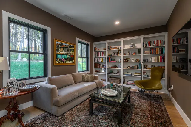 a living room with furniture and a floor to ceiling window