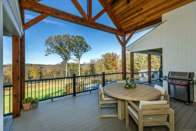a view of a balcony with mountain view and wooden floor