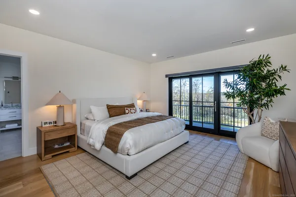 a spacious bedroom with a bed and a large window