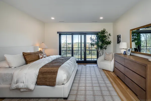 a spacious bedroom with a large bed and a large window