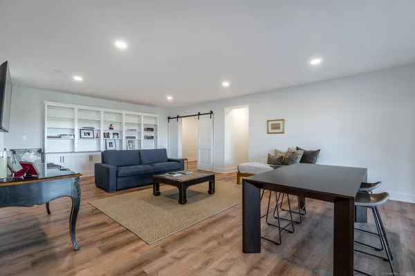 a living room with furniture and a wooden floor
