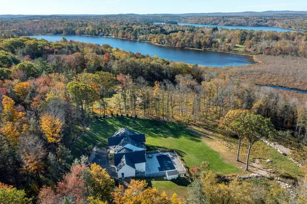an aerial view of residential houses with outdoor space and river