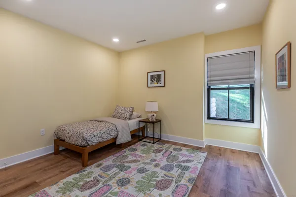 a view of room with window and wooden floor