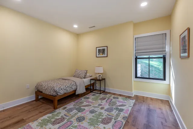 a view of room with window and wooden floor